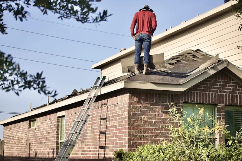 Professional roofer working on a residential roof in Lucaston